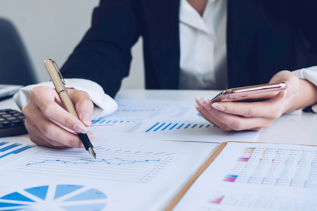 Seated person making notes in a chart.