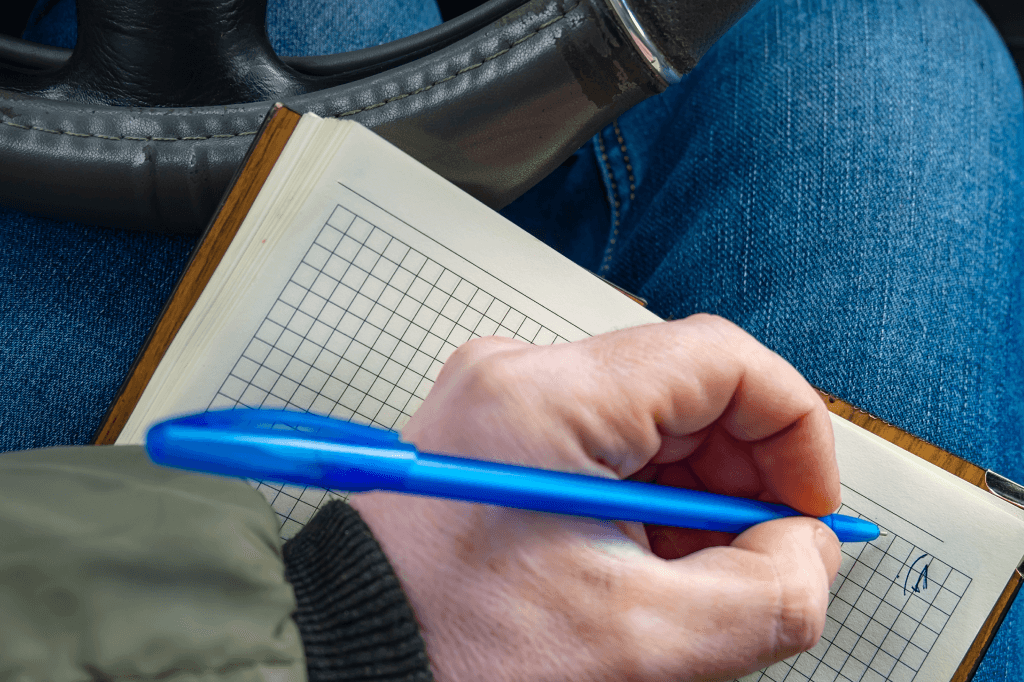 Person writing in a notebook.