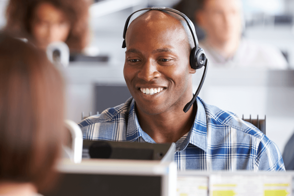 Broker wearing a headset and smiling.