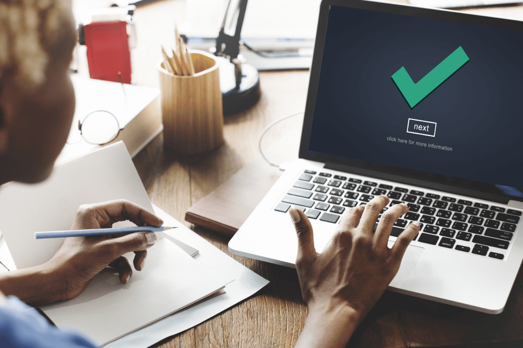 person using a computer and seeing a checkmark icon on the screen