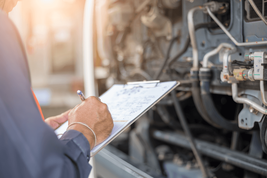 Person with clipboard reviewing equipment.