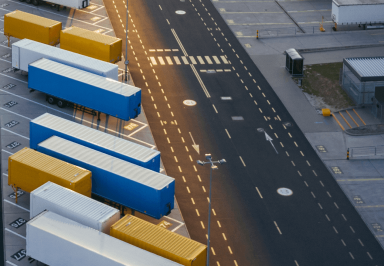 Aerial view of many trailers one behind the other at a shipping facility.