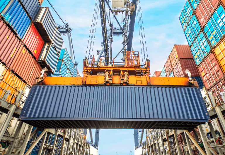 Crane moving a shipping container.