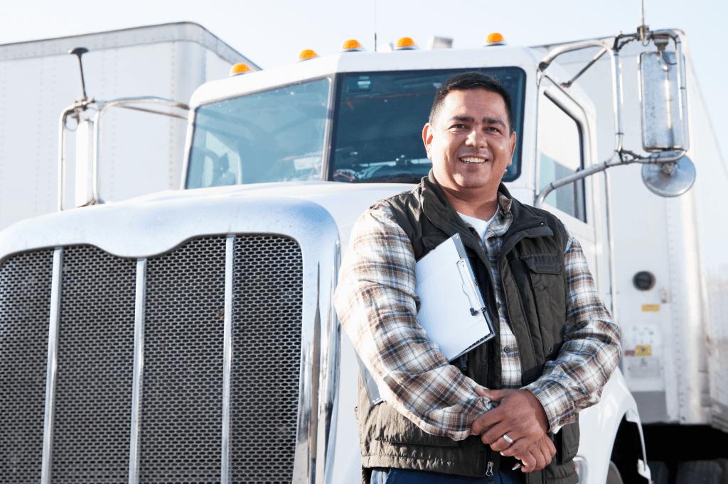 A Truckstop.com user standing in front of their truck.