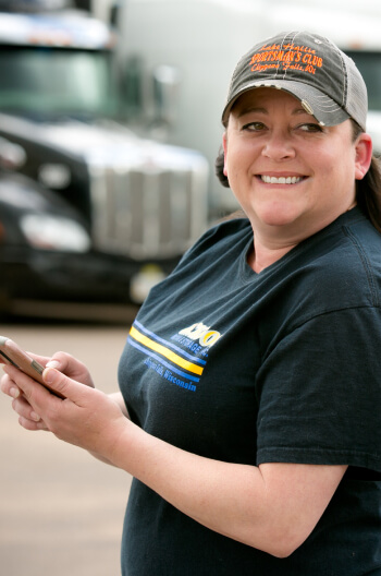 Mel Pink, a Truckstop.com customer, using her phone to find dry van loads for her carriers.