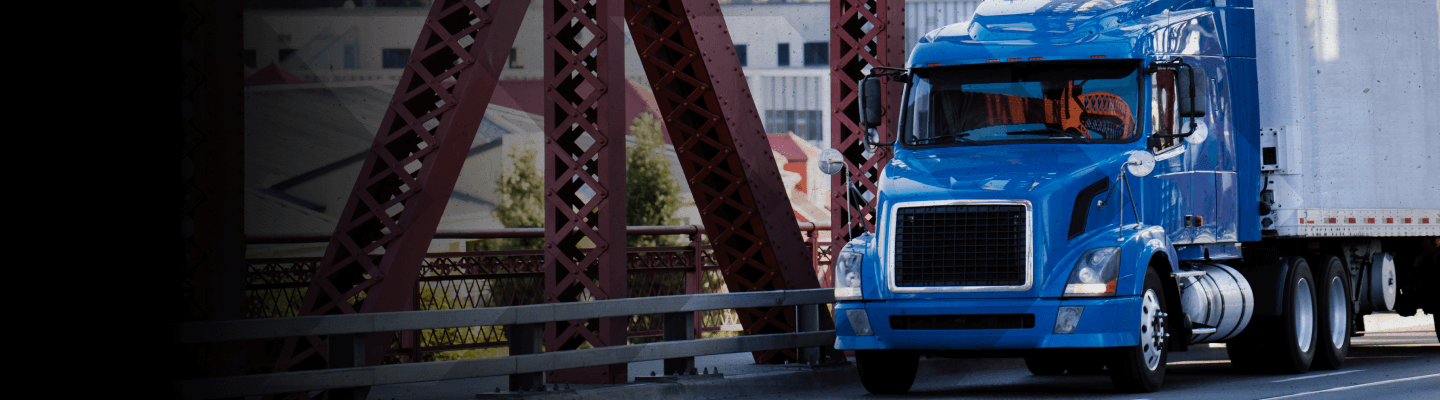 Truck and trailer crossing a bridge